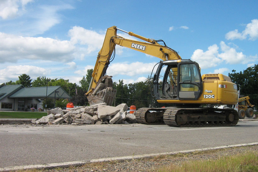 Kadlec Excavating backhoe at work in front of FirstLight Health Center, Highway 65, Mora, MN.