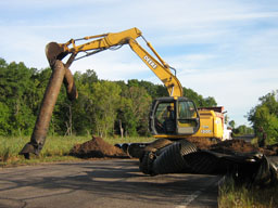 Kadlec Excavating removes old culvert with a backhoe.