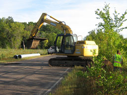 Kadlec Excavating removes tar with backhoe. (close up)